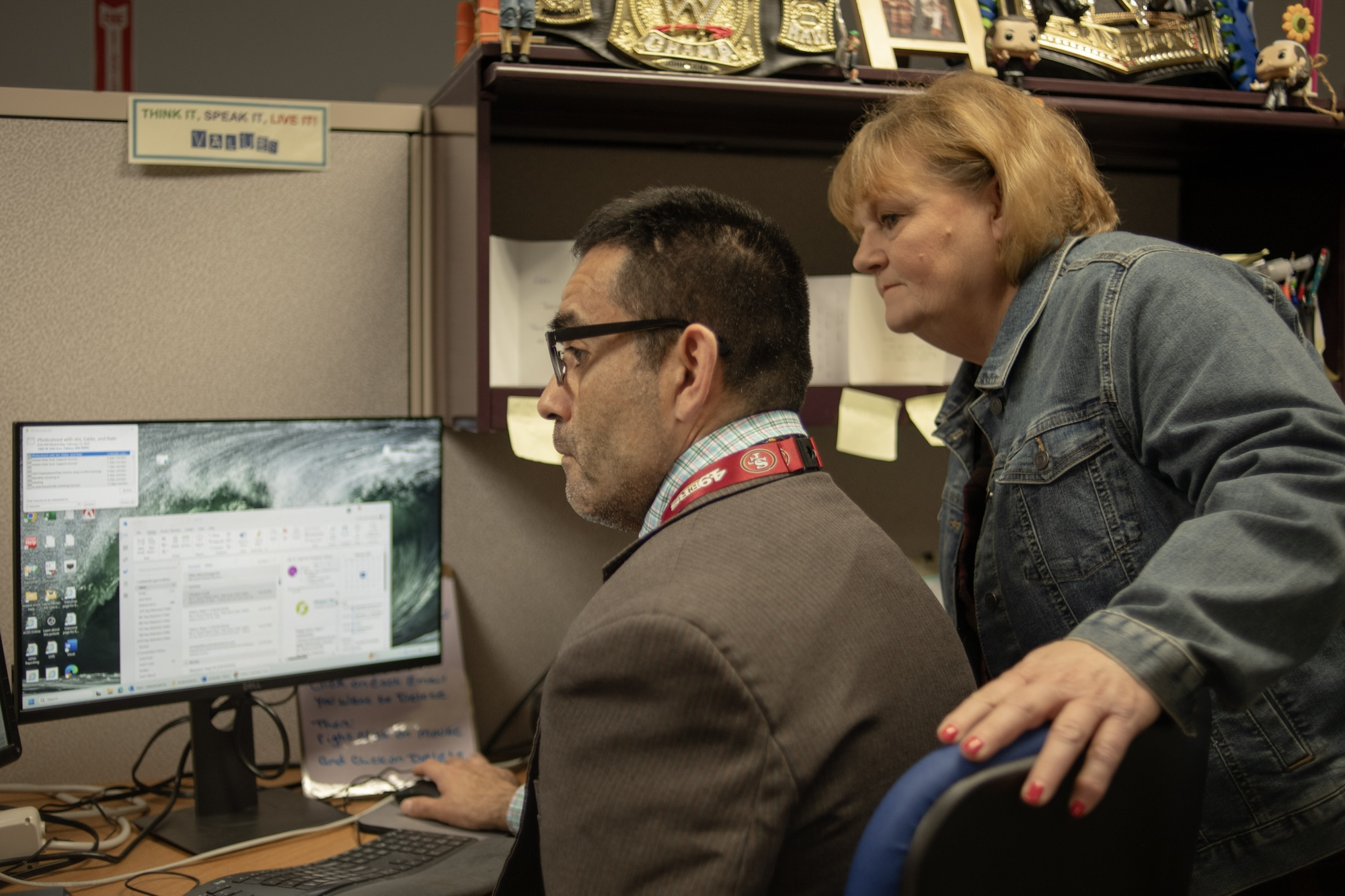 Nate and coworker at work at the computer